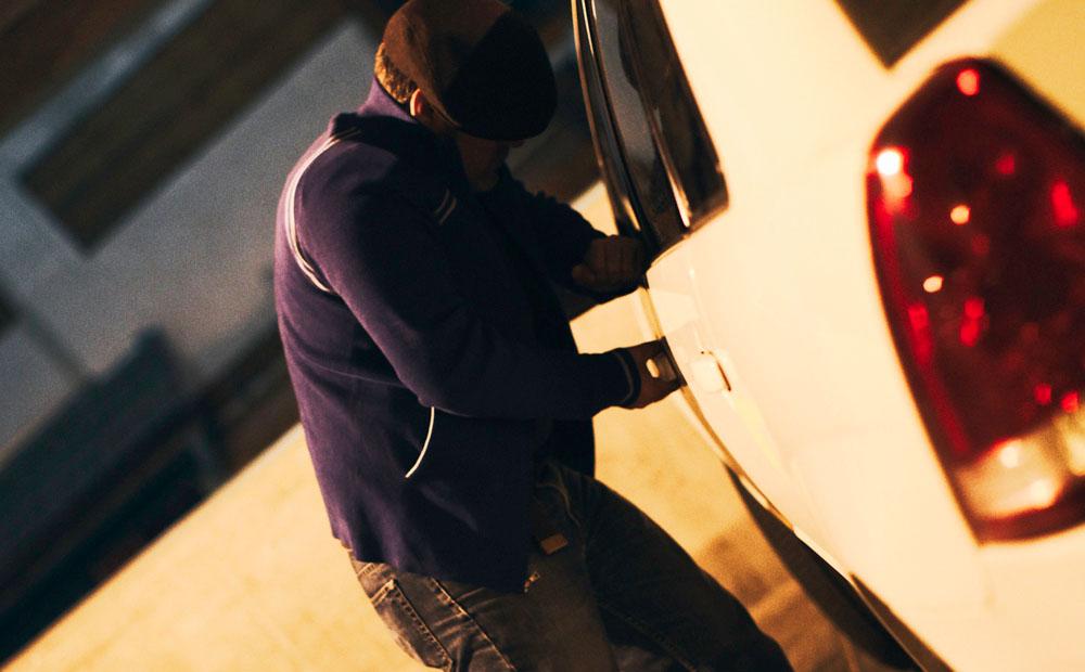 A man leaning on a car door.