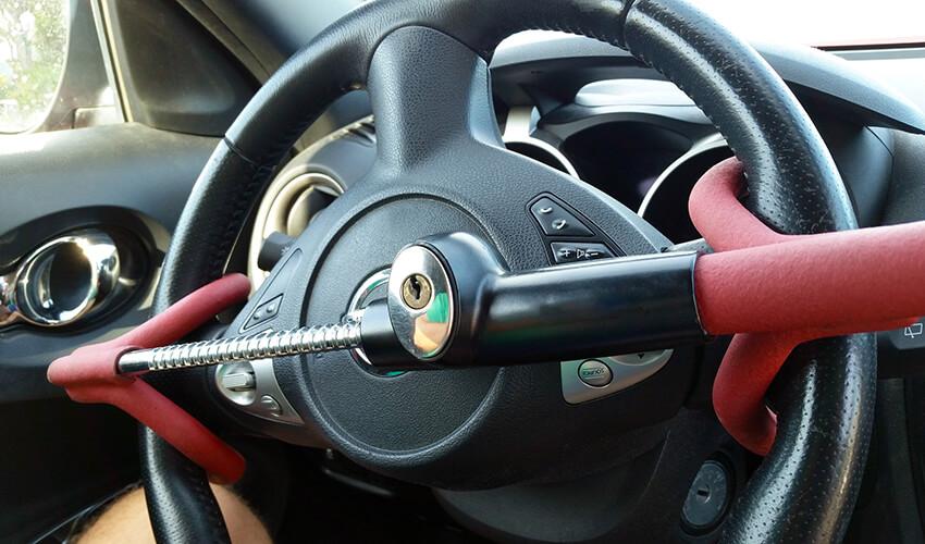 A steering wheel with a red handle.