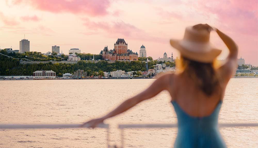 A woman in a hat looking at a city.