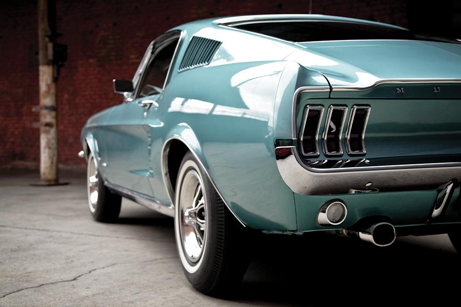 A blue mustang parked in a garage.