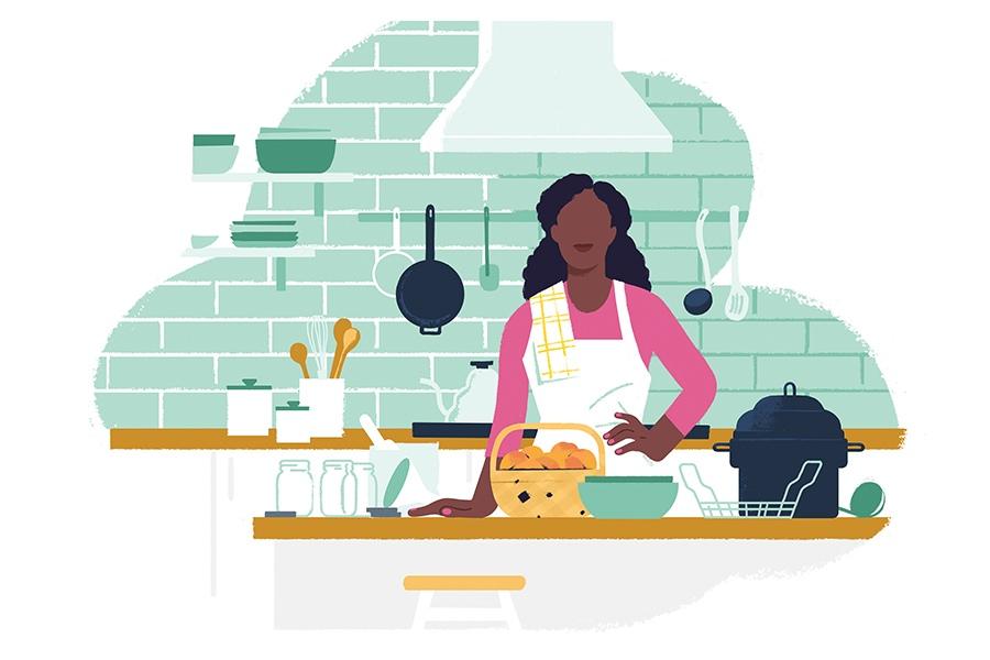 A woman in a apron is preparing food in the kitchen.
