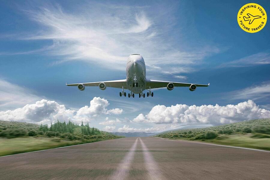 An airplane flying over a road.