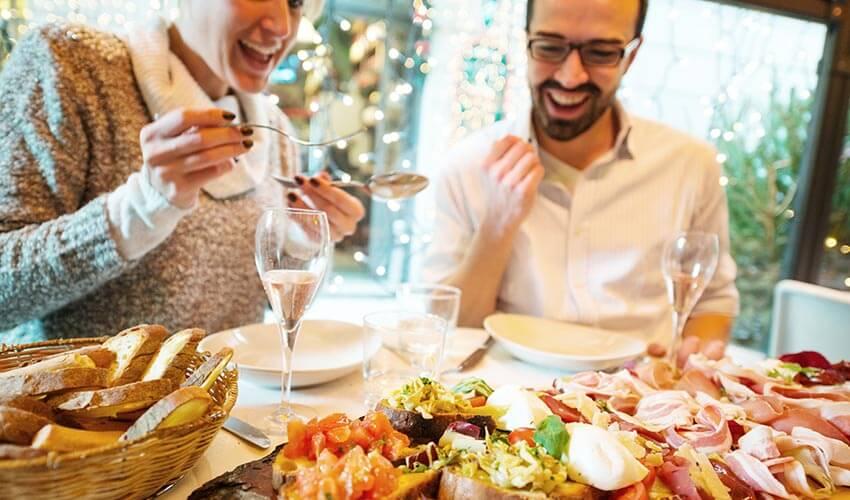 A man and woman enjoying a meal at a restaurant.