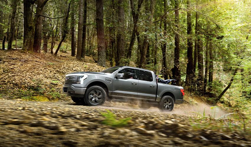 The 2019 nissan titan is driving through the woods.