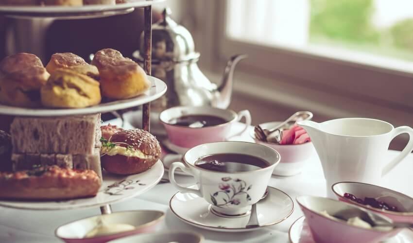 A table full of tea and pastries on a table.