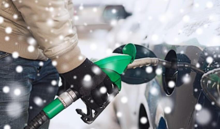 A person holding a gas pump.