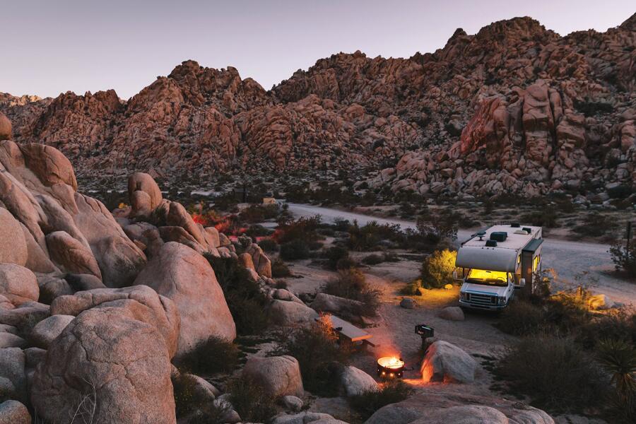 An rv parked in the desert near joshua tree.