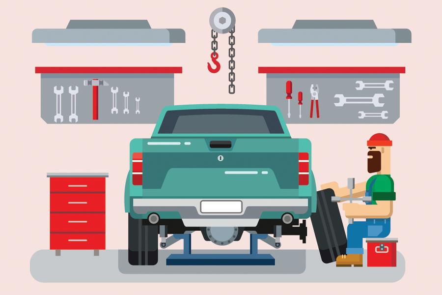 A man is working on a car in a garage.