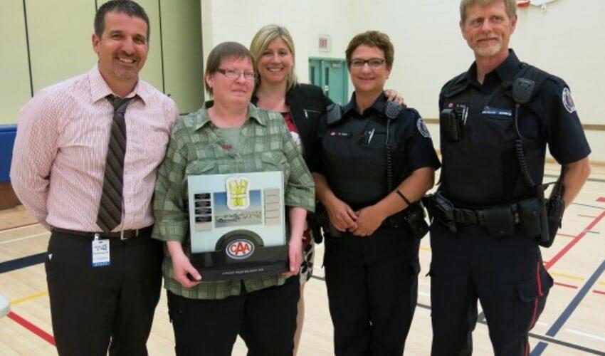 A group of police officers posing with a plaque.