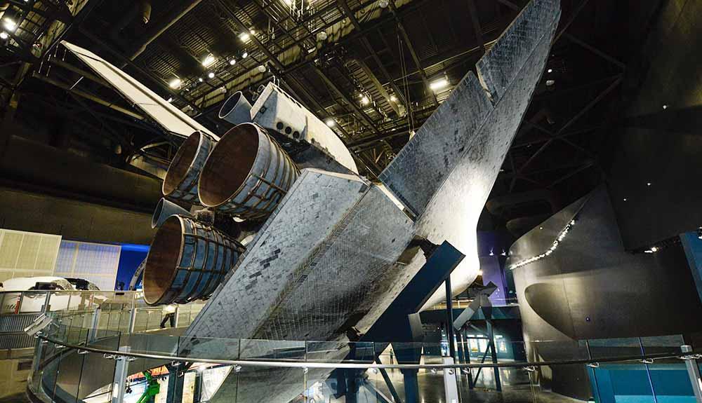 A space shuttle is on display in a museum.