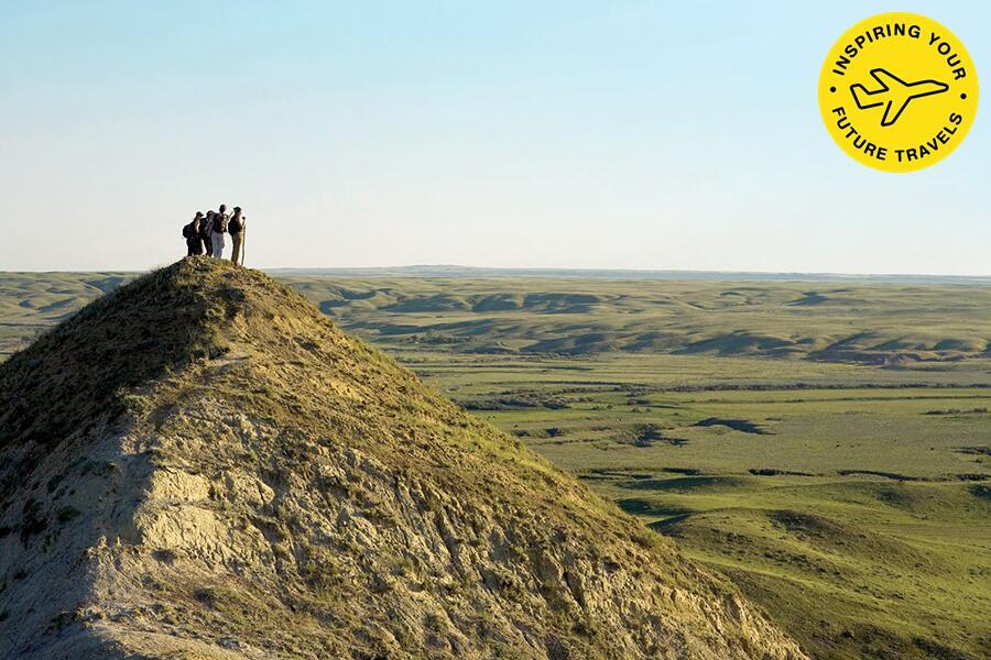 A group of people standing on top of a hill.