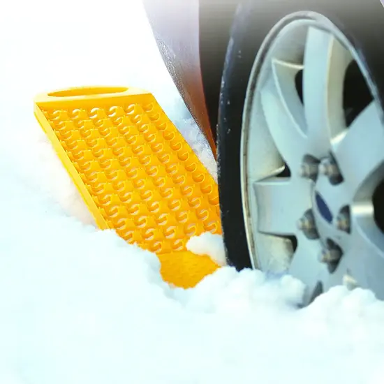A yellow plastic object on a car tire.